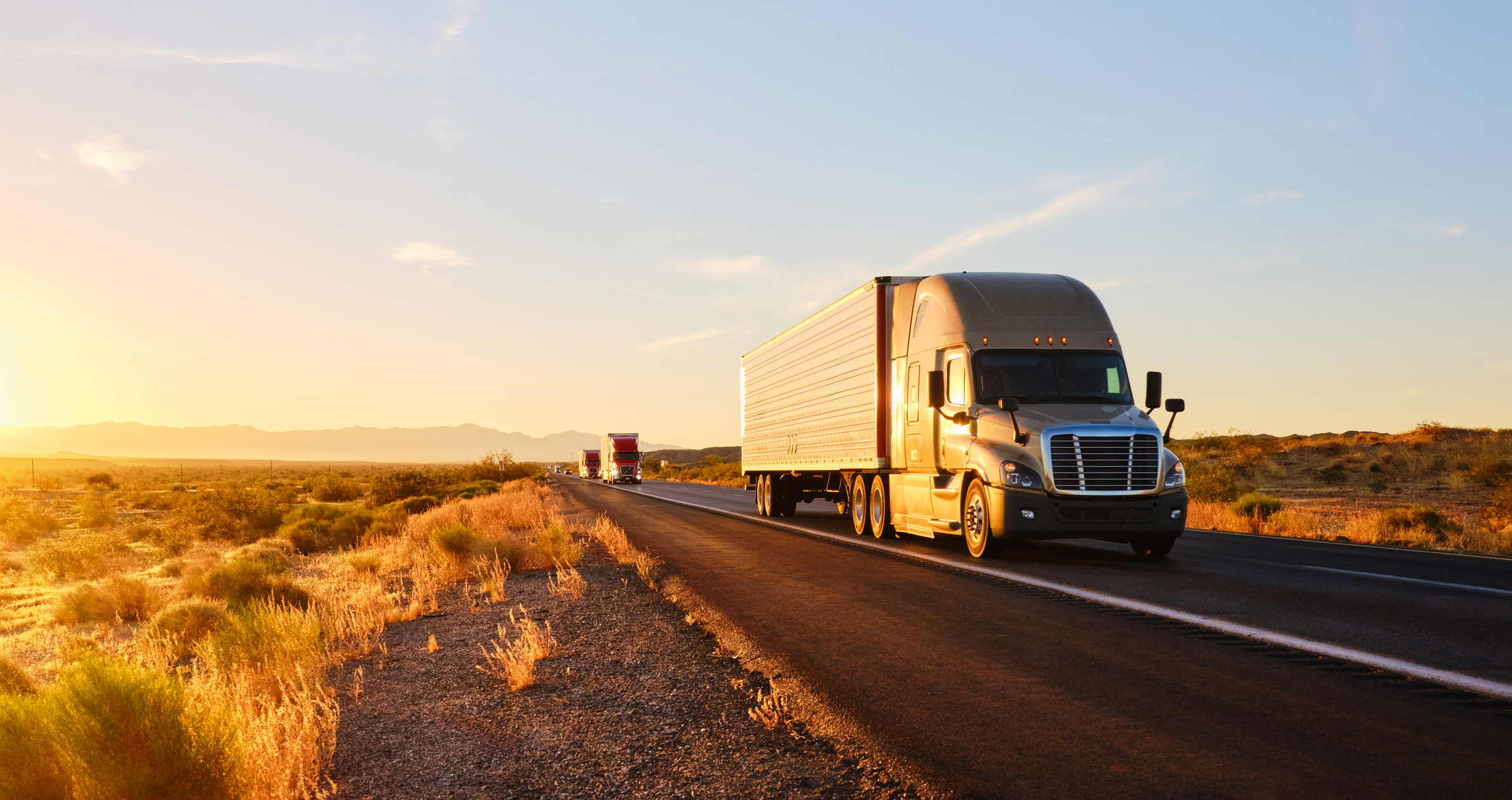 Trucks on Highway at Sunrise